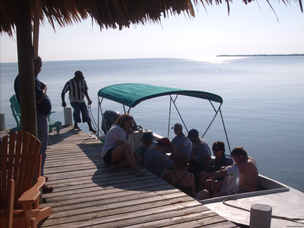 Boat picks up Green Parrot guests at the dock for trip | Green Parrot Beach Houses & Resort | Image #23/24 | 