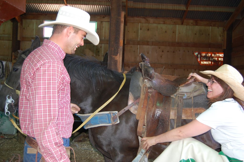 Guide mounting a guest | Fantastic Horseback Riding in Yellowstone Country | Image #14/15 | 