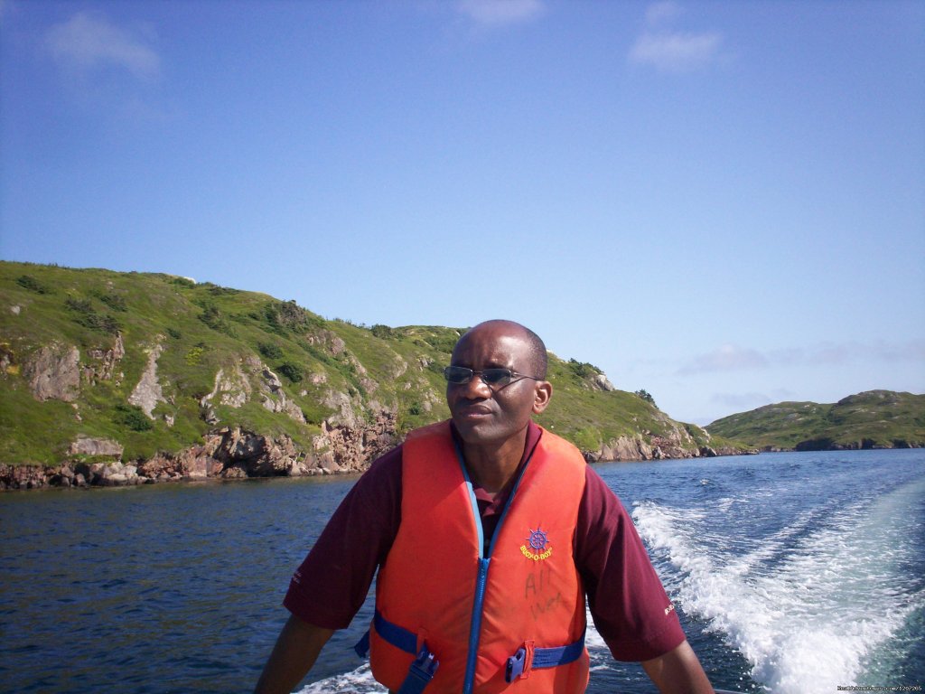 Reverend wilson operating the rowboat. | Burgeo Haven Inn on the Sea Bed & Breakfast | Image #7/16 | 