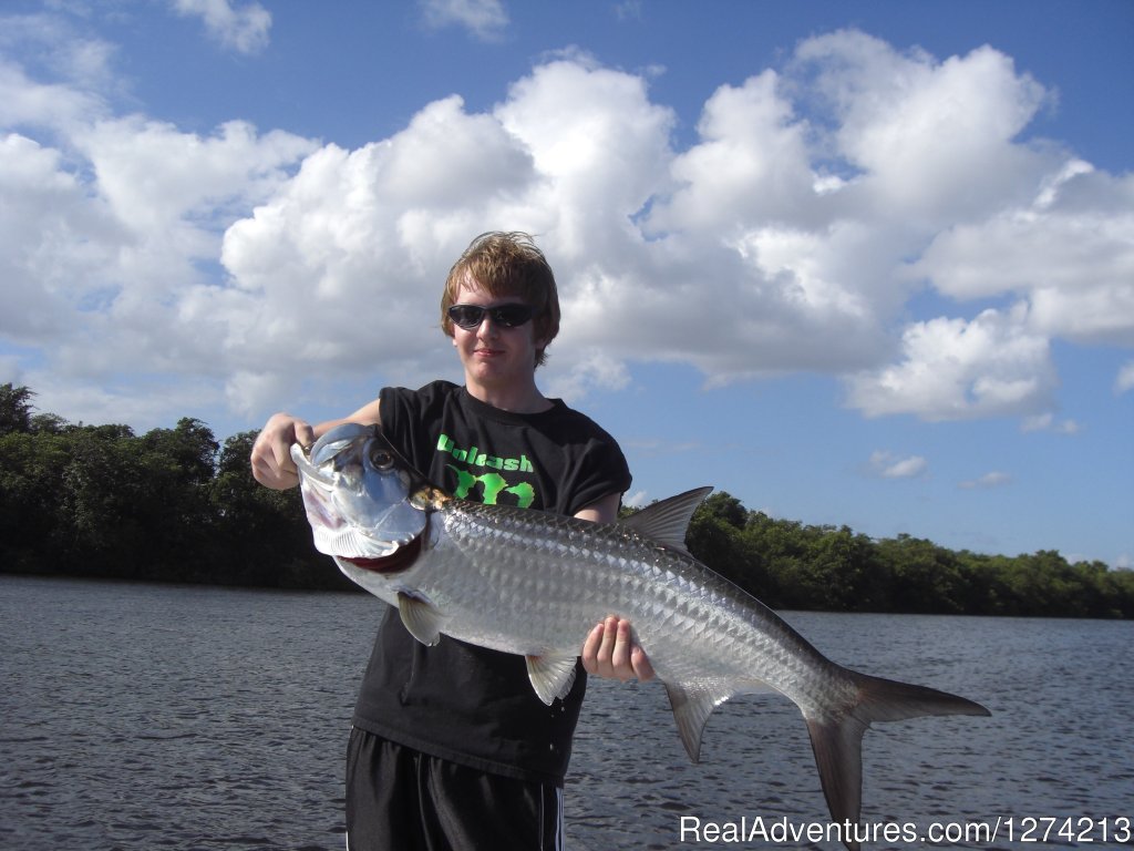 Kid with his Tarpon | Tarpon And Snook Fishing In San Juan | Image #4/10 | 