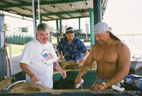 Captain Clay Showing Customers How To Clean The Fish | Bayou Log Cabins | Image #9/13 | 