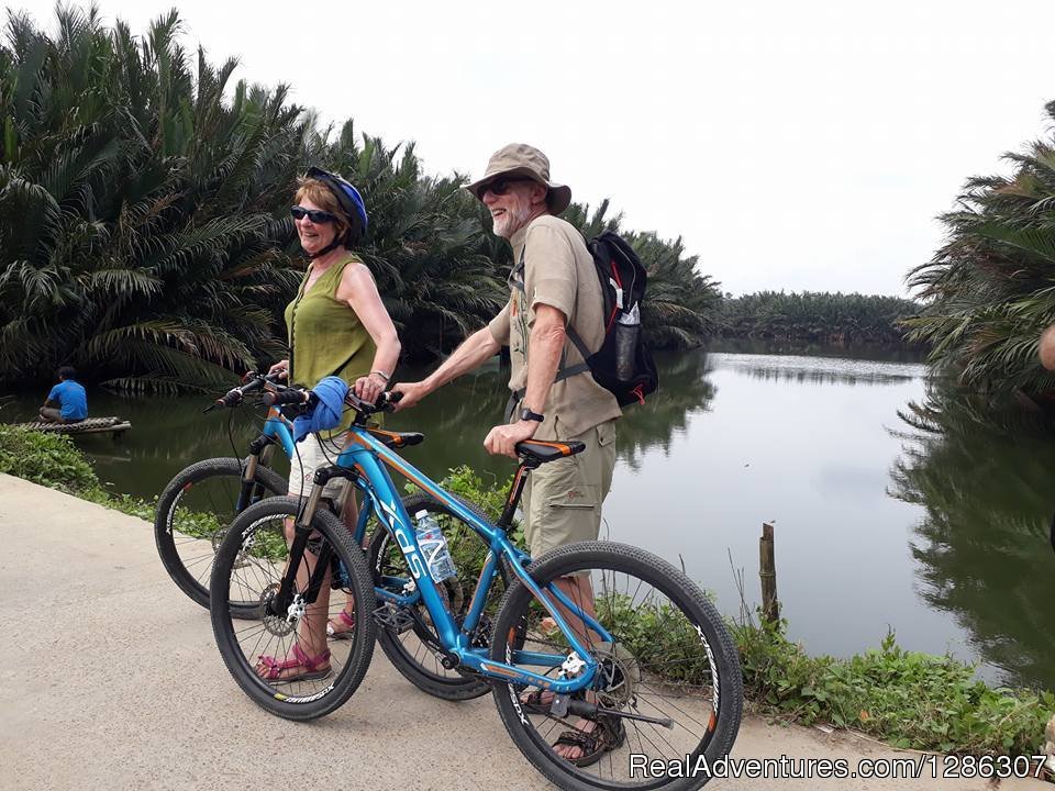 Cycling along canals with water palm trees | Easy cycling to rice farms Mekong Delta Vietnam | Image #3/4 | 